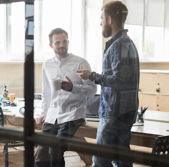 Two business advisors discussing Corporate Tax documents